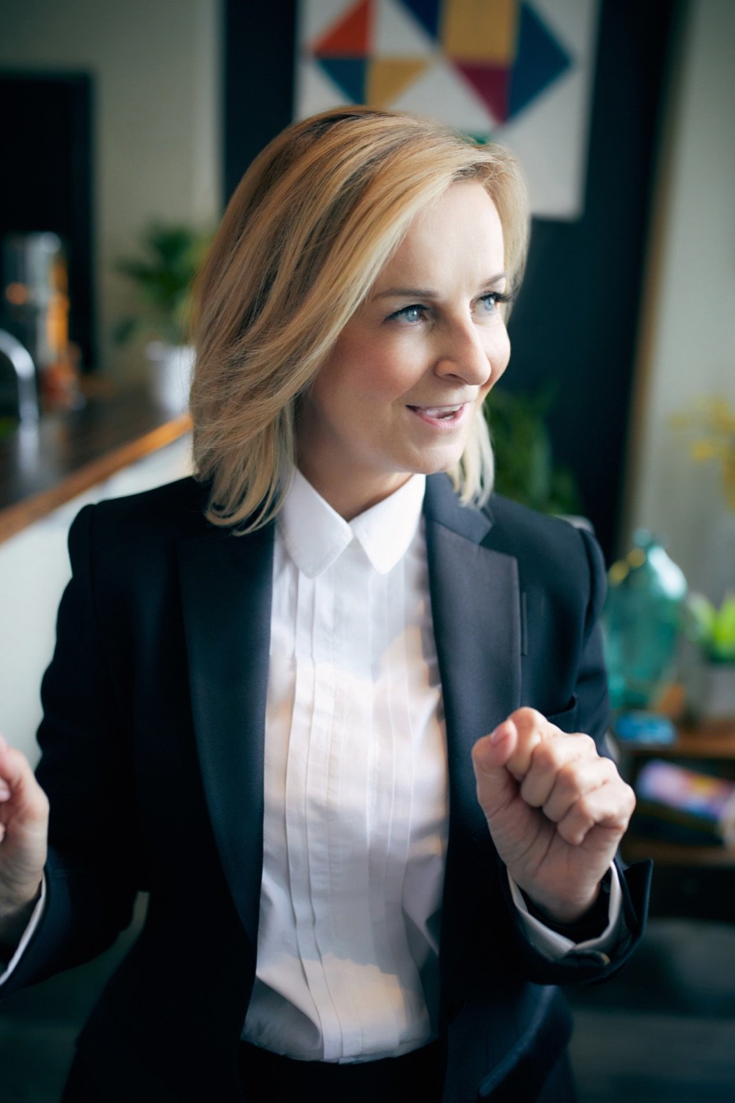 Tracy Quinton mid-conversation in a navy suit